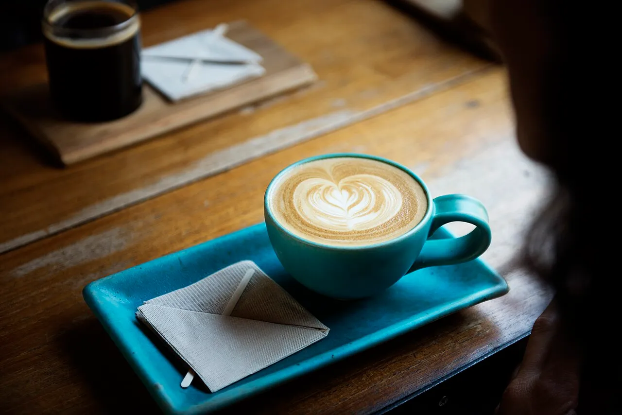 Coffee with latte art in a blue cup