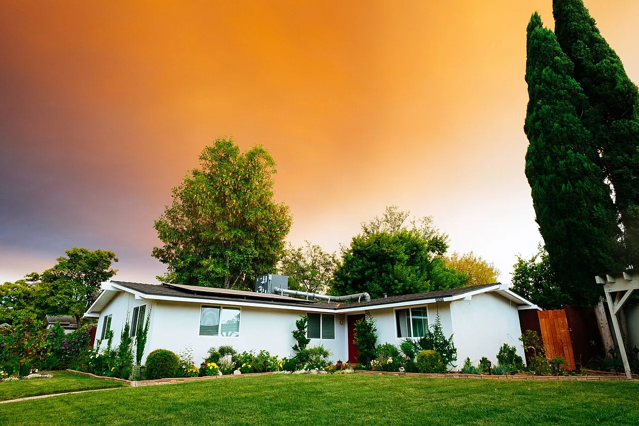 A welcoming white house surrounded by greenery